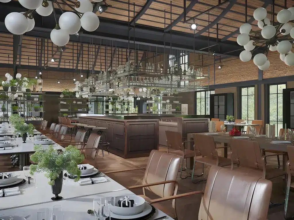 ร้านอาหารสมัยใหม่ภายในตกแต่งด้วยเก้าอี้หนังสีแทน โต๊ะรับประทานอาหารจัดวางอย่างเป็นระเบียบ และบาร์ขนาดใหญ่ตรงกลาง—เหมาะสำหรับการพักผ่อนหลังจากท่องเที่ยวเขาใหญ่ หรือเป็นสถานที่รับประทานอาหารสุดเก๋ท่ามกลางแหล่งท่องเที่ยวเขาใหญ่.